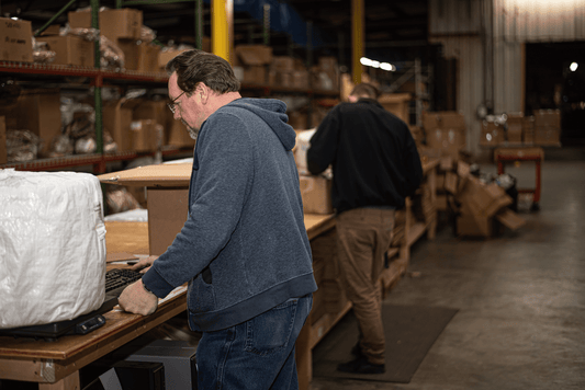 Man calculating warehouse costs for his business