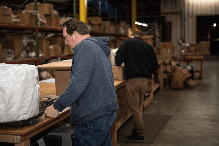 Man calculating warehouse costs for his business